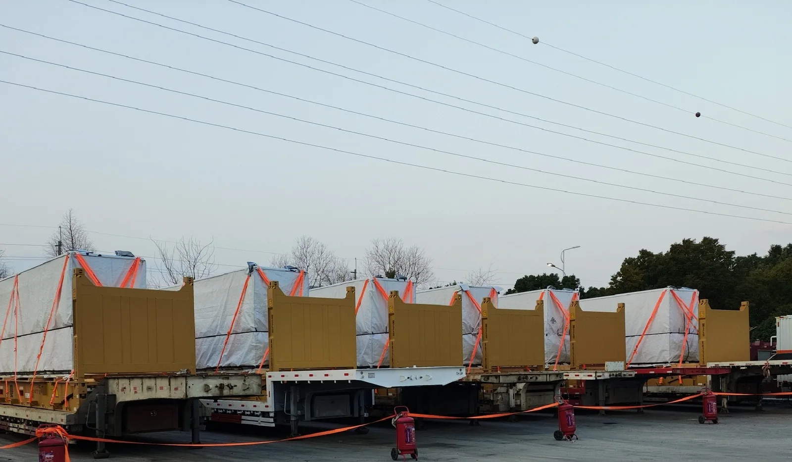 Heavy cargo lineup on flat rack trailers